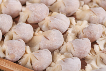 Fresh Homemade Meat Wontons on Wood Surface - Traditional Asian Dumplings Ready for Cooking