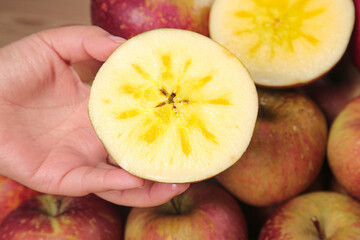 Fresh Apple Slice with Star Core Pattern Held in Hand - Healthy Organic Fruit Concept