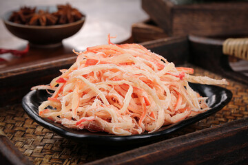 Dried Shredded Squid Seafood Snack on Black Plate with Asian Spices Studio Photography