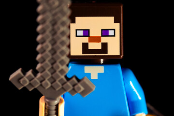 Obraz premium LEGO Minecraft Steve face closeup with a sword on a black background