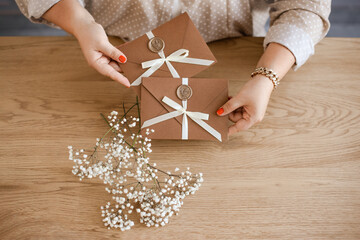 invitation card envelope for celebration wedding, Gift Certificates on woman hands with flowers