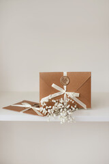 Two Gift Certificates envelope with seal and bow on white background