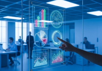 A person's hand interacts with a futuristic holographic display showing various charts and graphs in a modern office environment.