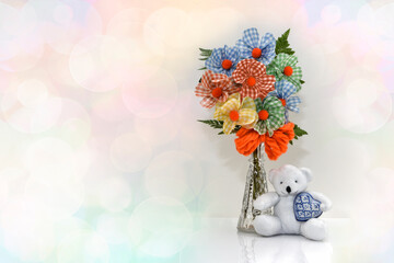 Colorful flowers with teddy bear holding heart