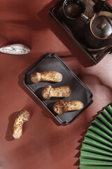 Fresh Wild Matsutake Mushrooms in Cooking Pan with Traditional Tea Set for Gourmet Cuisine