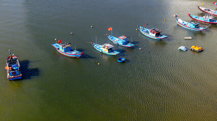 Obraz premium Colorful fishing boats floating on calm waters