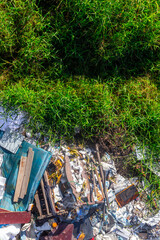 Environmental pollution: garbage pile in green natural setting