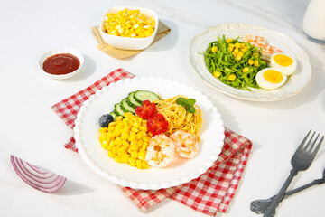 Delicious corn kernel salad and healthy meal plates with fresh vegetables and shrimp