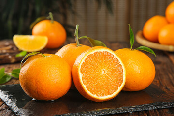 Fresh Oranges Display on Rustic Wooden Table with Cut Halves Showing Juicy Interior