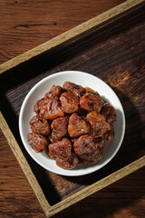 Fujian Gaozhou Dried Lychee Fruit in Bowl on Wooden Tray - Traditional Chinese Healthy Snack Food Ingredient