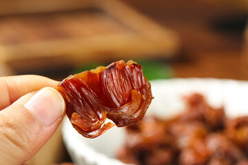 Dried Lychee Fruit from Fujian China - Traditional Asian Snack Food Held in Hand
