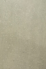 Obraz premium Textured wall surface with subtle patterns and earthy tones in a well-lit environment during daylight hours