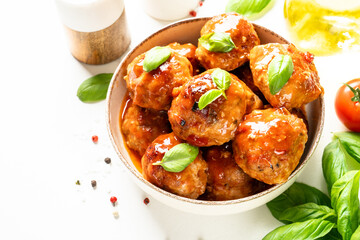 Meatballs in tomato sauce, glazed meatballs on white table.