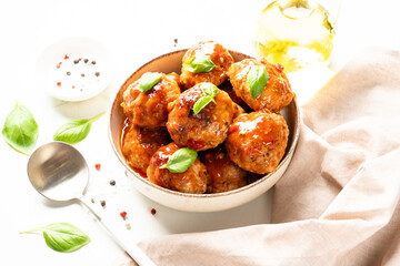 Meatballs in tomato sauce, glazed meatballs in craft plate on white table.