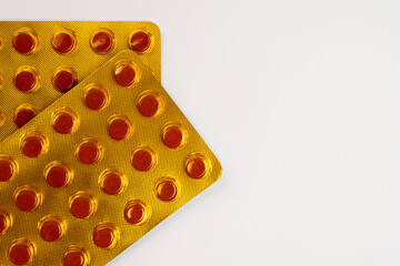 Yellow blister pack of tuberculosis tablets isolated on a white background with a coffee space. Tuberculosis medication in the pack in the 4th month of consumption period.