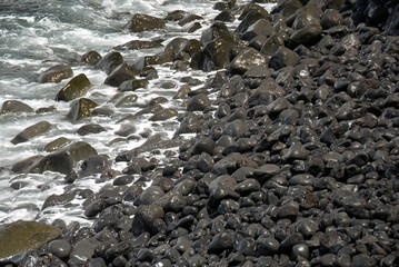 Obraz premium Pebbles of olivine basalt. Los Hervideros, Lanzarote, Canary Islands, Spain
