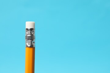 One graphite pencil on light blue background, closeup. Space for text