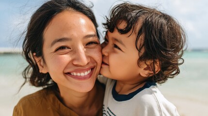 Fototapeta premium Woman hugging child at beach.