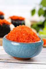 Korean Fish Roe Caviar in Blue Bowl with Sushi - Asian Cuisine Delicacy