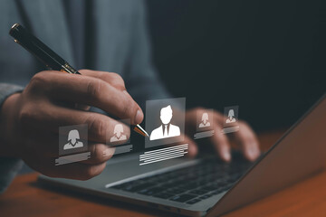 Businessman using laptop with digital profile icons, symbolizing online recruitment, candidate selection, human resources management, digital hiring, job application process, and workforce solutions.