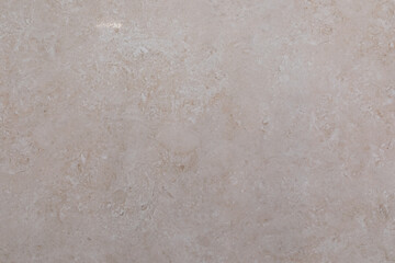 Smooth beige stone surface showcasing natural patterns and textures ideal for home decor