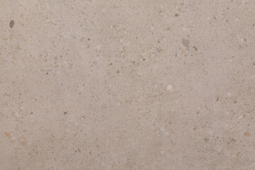 Light beige textured surface showcasing natural variations and small stones in a contemporary setting