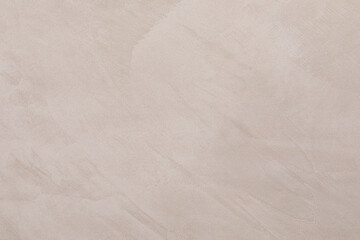 Smooth beige plaster wall with subtle texture ideal for modern interior design projects