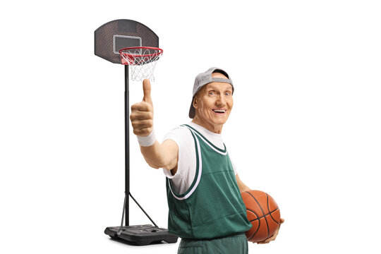 Senior with a basketball showing thumbs up and smiling