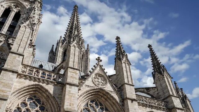 Gothic Cathedral Architecture Against Blue Sky With Clouds.
