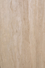 Natural stone wall featuring soft beige tones and subtle veining in a modern interior space