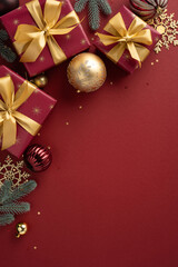 Elegant vertical Christmas presents adorned with gold ribbons, baubles, and festive decorations on a vibrant red backdrop