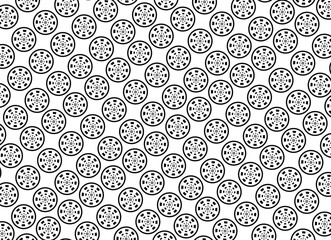 Intricate black and white pattern of repeating circular motifs with radial symmetry