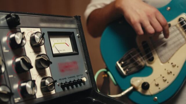 Bass guitar being played in a recording studio, rehearsal room, man playing jazz close up macro, vintage recording equipment