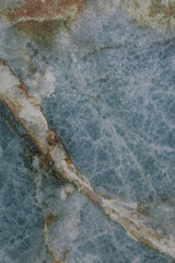 Natural stone surface featuring a stunning blue and white marble pattern with unique veins and textures