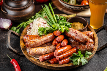 Grilled sausages with herbs and mustard on a wooden platter