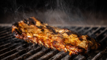 Smoky grilled pork ribs on barbecue grill