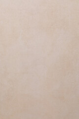 Fototapeta premium Light beige textured wall creates a warm backdrop for interior design in a modern space