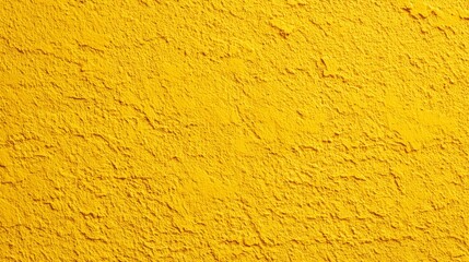 Fototapeta premium Vibrant yellow textured wall surface with rough plaster pattern