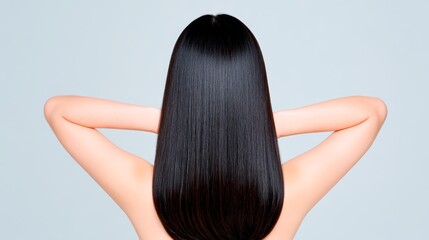 Asian female with smooth straight black hair posing from back view