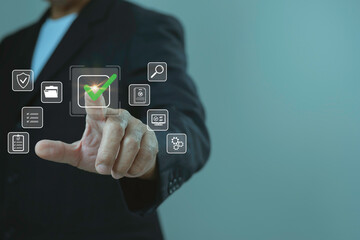 Businessman hand pressing digital check mark icon on virtual interface, concept of approval, quality assurance, compliance, document management and online security system.