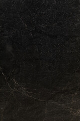 Dark textured stone surface with subtle patterns and natural imperfections suitable for various design projects