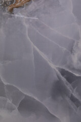 Beautiful abstract close-up of a translucent grey stone with intricate patterns and textures