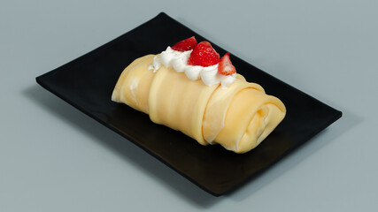 Piece of cake on black tray