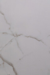 Marble surface with white and gray veins showing natural patterns and cracks in detail