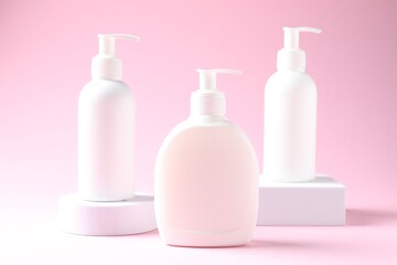 Promotion. Cosmetic products and podiums on pink background