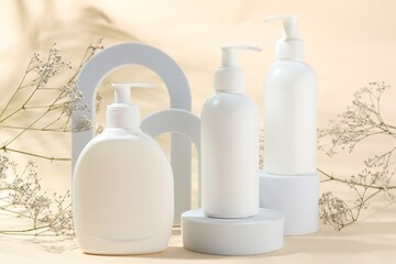 Promotion. Cosmetic products, podiums and gypsophila flowers on beige background