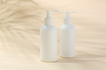 Promotion. Bottles of cosmetic products on beige background