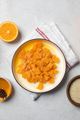 Healthy dessert with sliced pumpkin, honey and orange juice in a bowl. Healthy pumpkin dish.