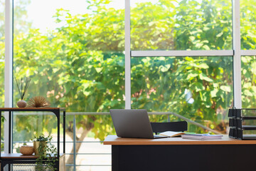 Home workspace. Modern laptop and stationery on wooden desk indoors