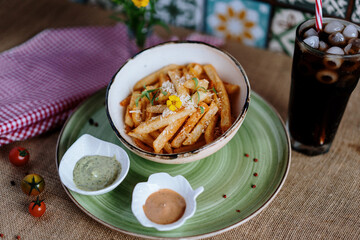fried potato's in a bowl whit cheese and souse  